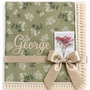 Botanica green floral muslin baby blanket with George embroidered in cream, fringed edging and champagne ribbon.