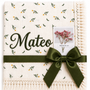 Cream Dandelions muslin blanket with delicate green and yellow botanical print, Mateo name embroidery and dark-green ribbon.