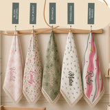 DreamBuy muslin blanket design guide showing Blush Naturel, Tulip Burst, Botanica, Dandelions and Summer Waves, each with name embroidery.