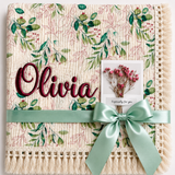 Olives patterned muslin baby blanket with Olivia embroidered in burgundy, cream fringe and mint ribbon.