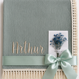 Thyme green muslin baby blanket embroidered with Arthur, with cream fringe and a mint ribbon.