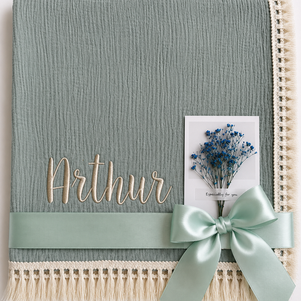 Thyme green muslin baby blanket embroidered with Arthur, with cream fringe and a mint ribbon.