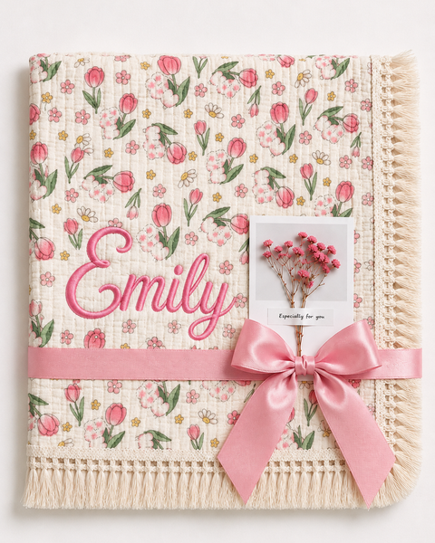 Tulip Burst muslin baby blanket with pink tulip print, Emily embroidered in pink, cream fringe and pink ribbon.