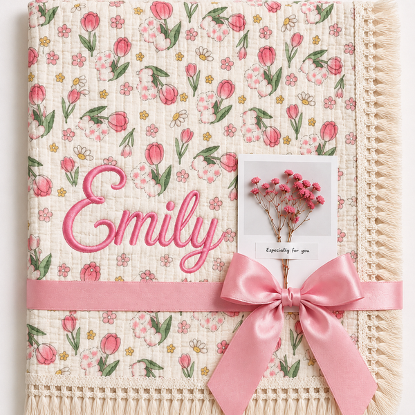 Tulip Burst muslin baby blanket with pink tulip print, Emily embroidered in pink, cream fringe and pink ribbon.